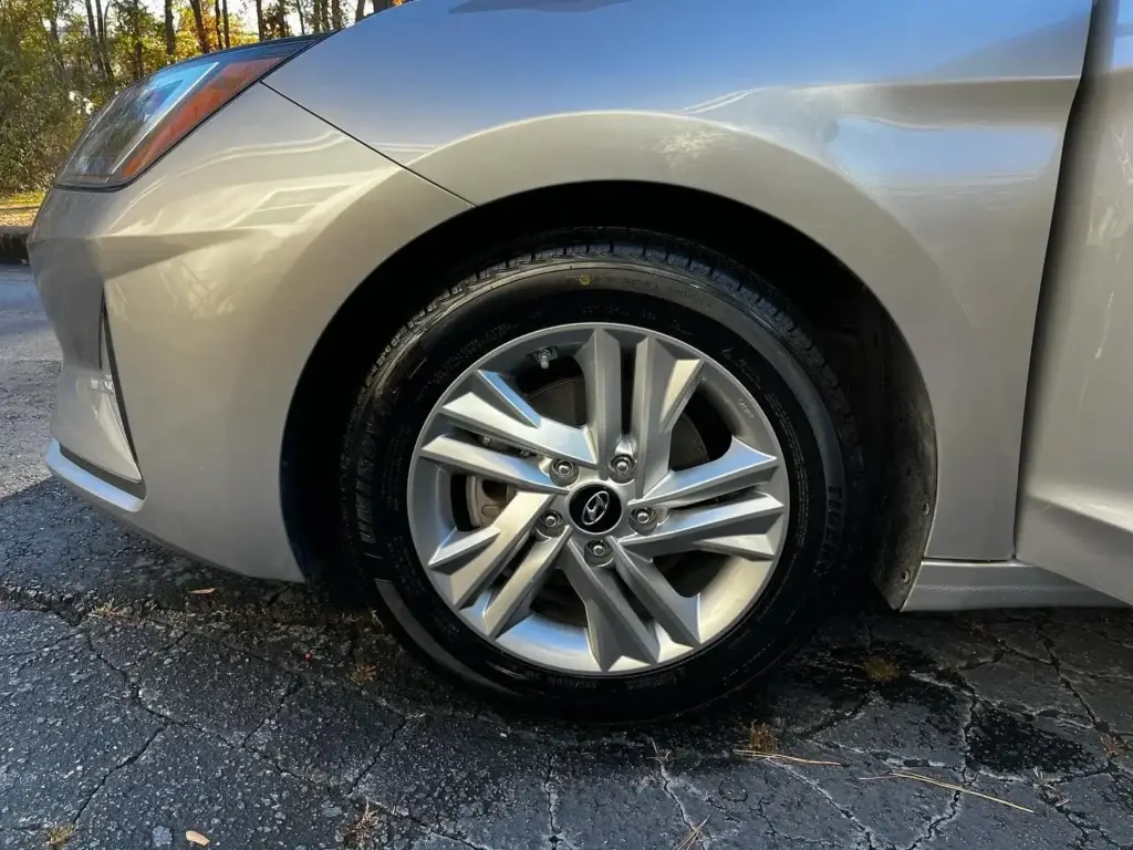 The same alloy wheel cleaned back to bare silver after a mobile wheel and tire detail in Spartanburg SC
