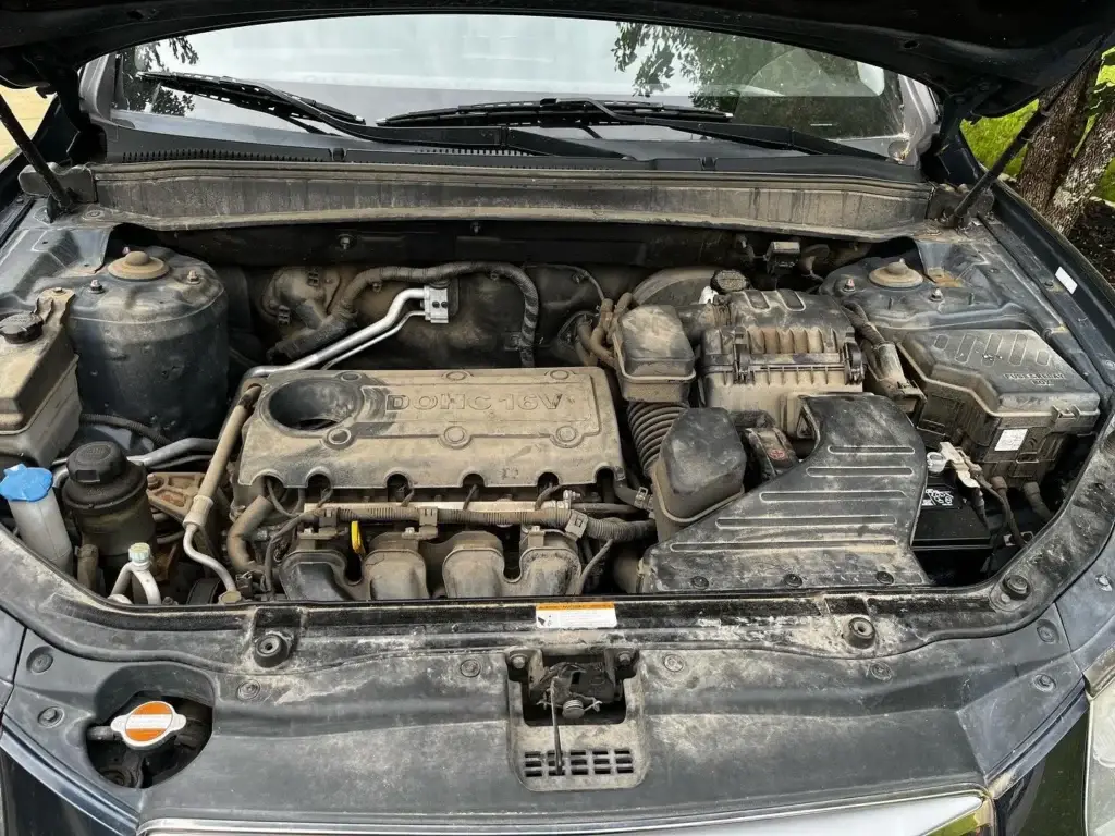 Grimy engine bay before a mobile engine bay detail in Spartanburg SC