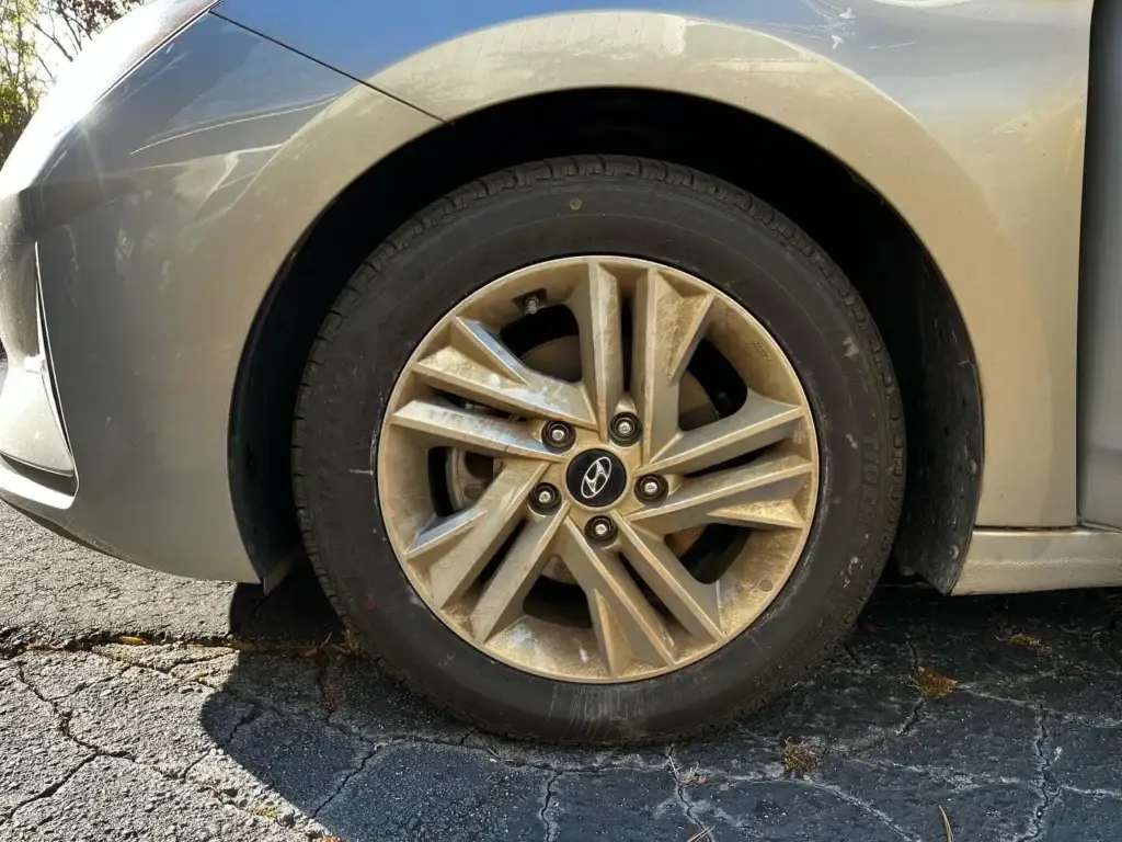 Alloy wheel caked in brake dust before a mobile wheel and tire detail in Spartanburg SC